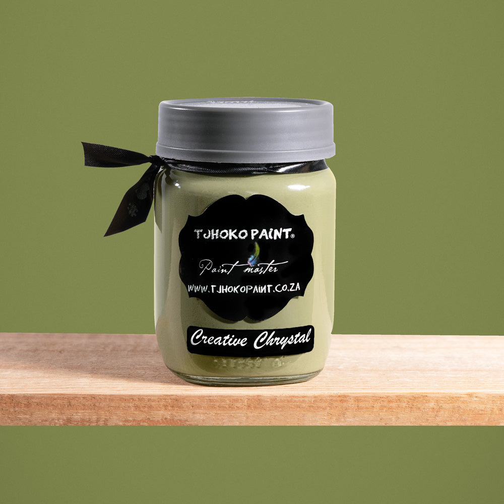 Creative Chrystal is a dark yet muted shade of olive green, reminiscent of sun-dappled leaves.
