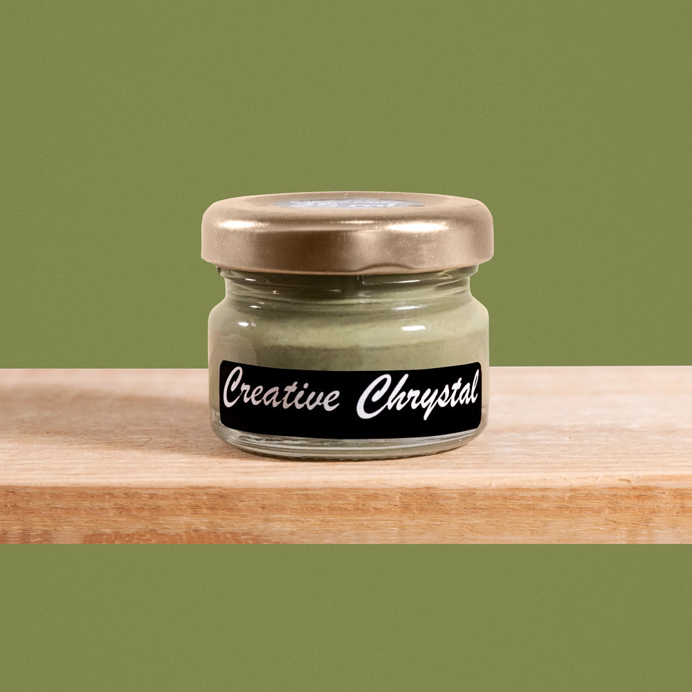 Creative Chrystal is a dark yet muted shade of olive green, reminiscent of sun-dappled leaves.