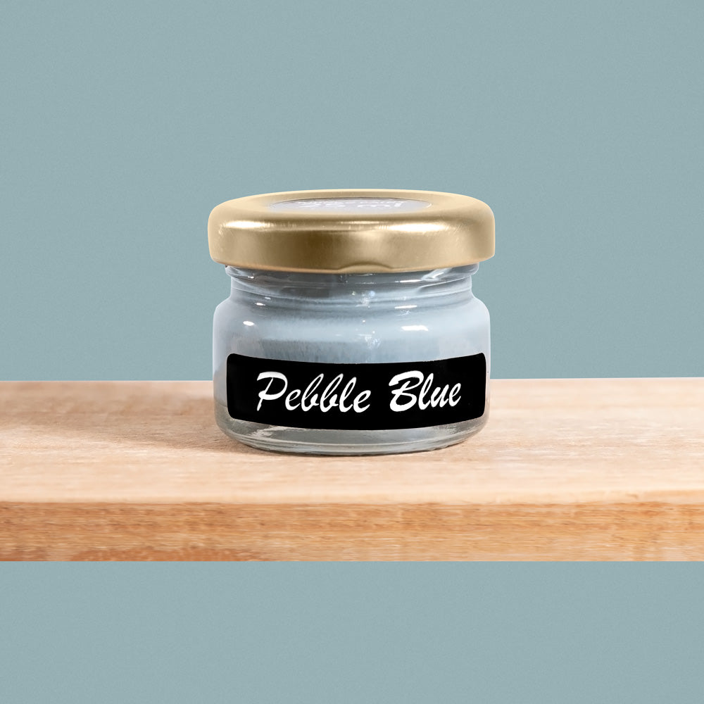 Pebble Blue is a tranquil shade of muted blue-gray, reminiscent of smooth pebbles washed ashore by gentle waves.